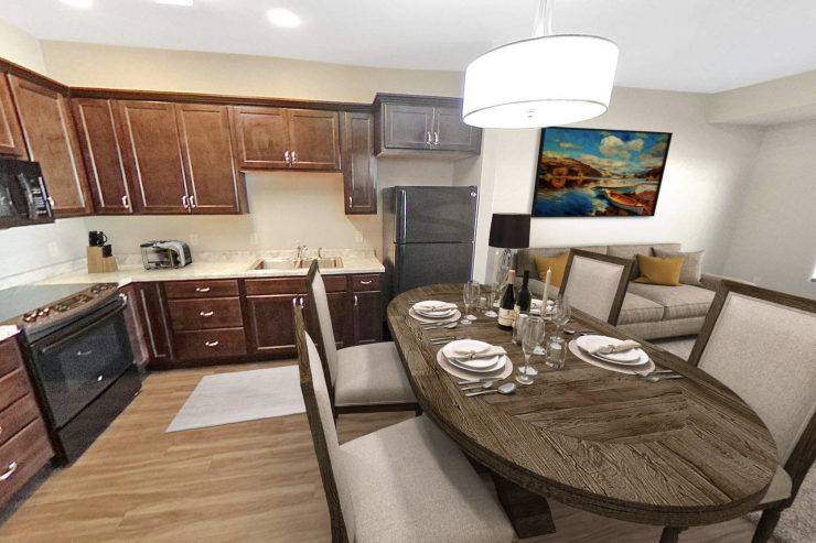 Warm dining and kitchen area with elegant table setting and comfortable living space.